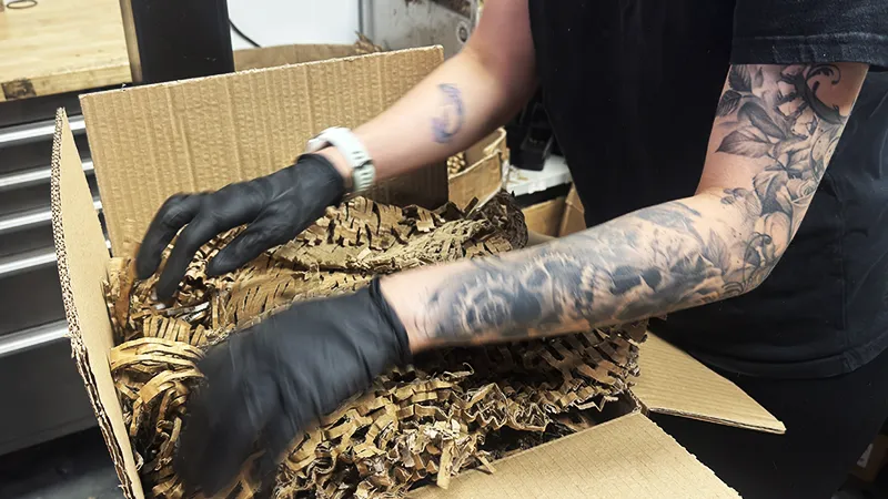 Protective filling being packed around the turbocharger to prevent movement