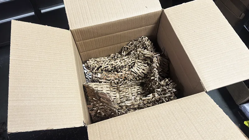 Cardboard turbocharger box prepared with protective cushioning at the bottom